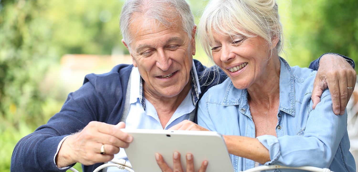 older couple reading tablet