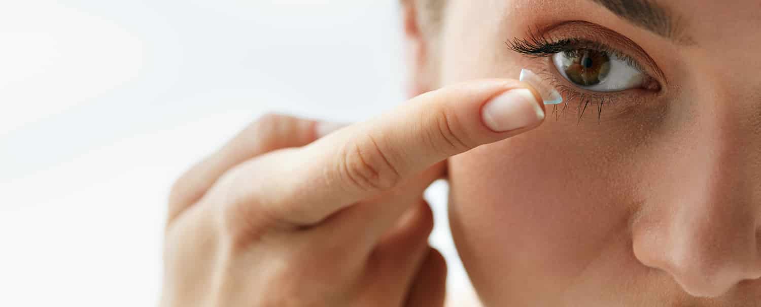 Woman putting in contact Lens